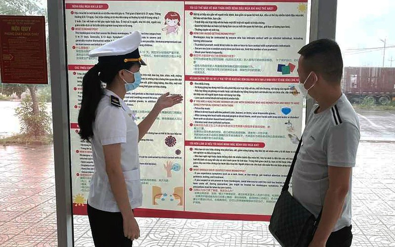Kiểm dịch viên của Trung tâm Kiểm dịch y tế quốc tế Quảng Ninh tuyên truyền về bệnh đậu mùa khỉ tại Cửa khẩu Bắc Luân II (TP Móng Cái) cho các chủ xe.