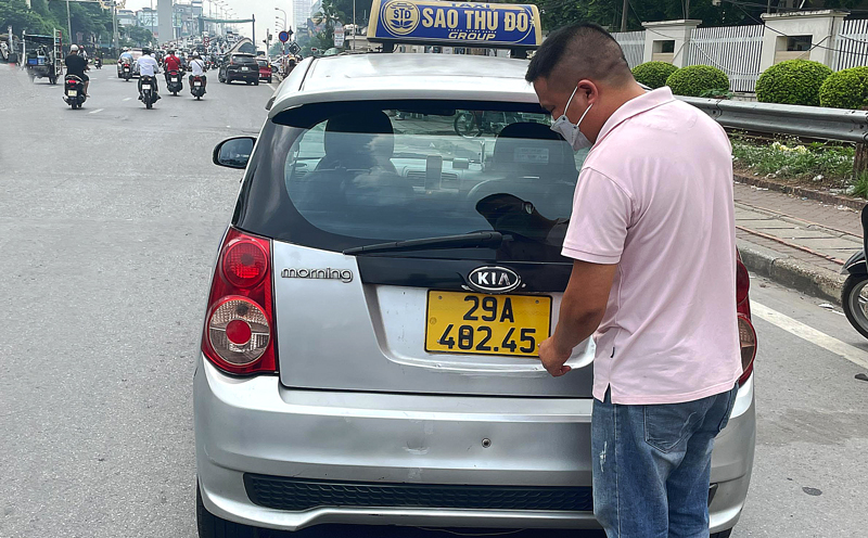 Tài xế xe taxi biển kiểm soát 29A-462.45 thay đổi thành 29A-482.45 bằng cách dán băng dính.